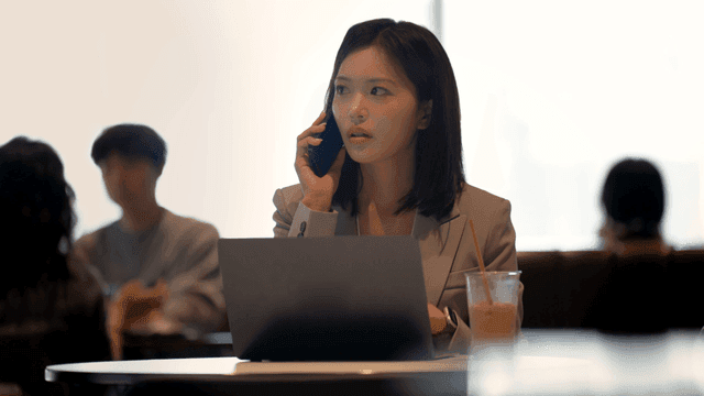 Working woman talking on phone at cafe