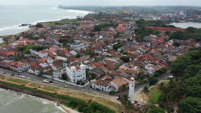 Coastal town view with lighthouse and historic buildings