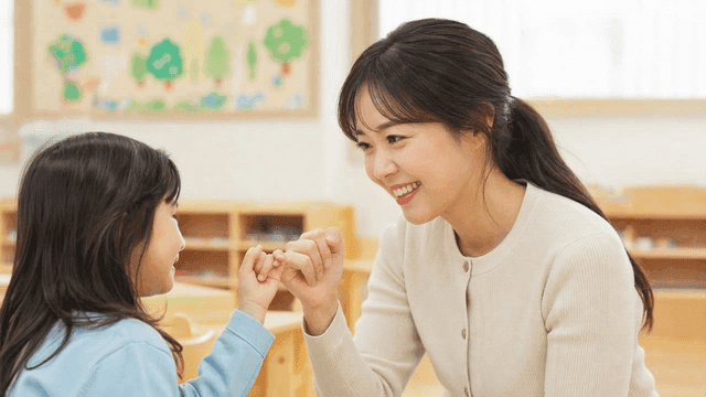 Kindergarten teacher and child make promise