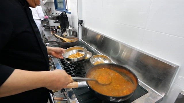 Chef preparing kalguksu with spicy sauce