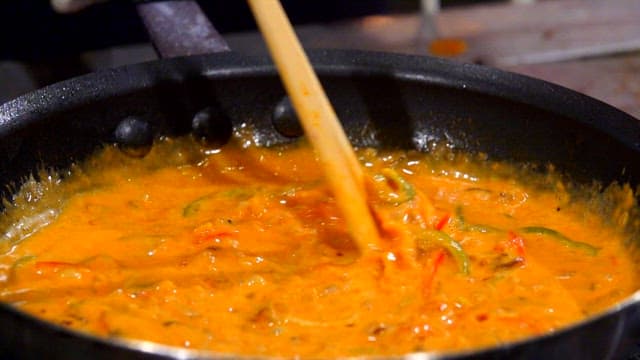 Rose cream sauce being stirred in a pan