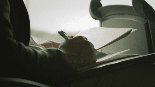 Person taking notes in notebook
