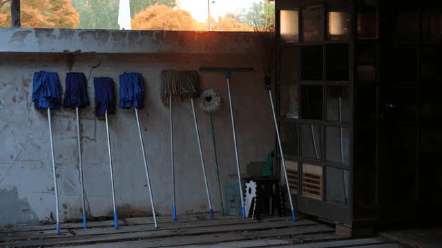 Cleaning tools arranged against a wall