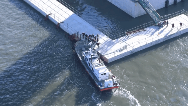 Workers waiting for a ship at the dock