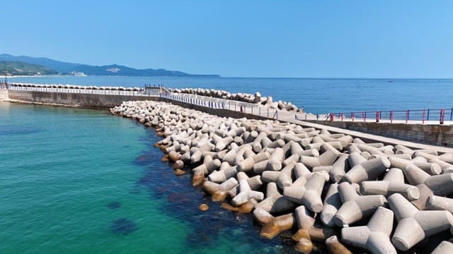 Coastal breakwater with clear blue sea