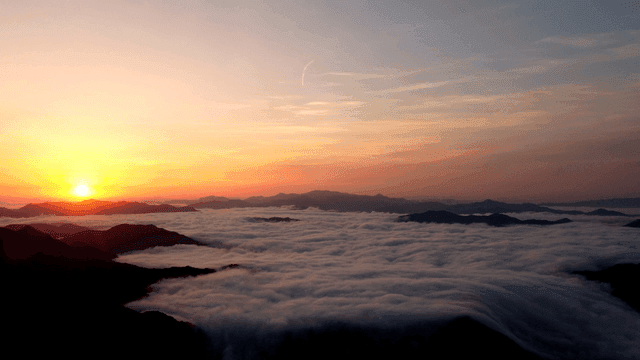 Sunrise over a sea of clouds and mountains