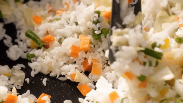 Colorful vegetable fried rice being cooked