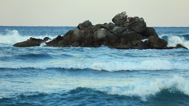 Rugged Rocks Amidst Ocean Waves