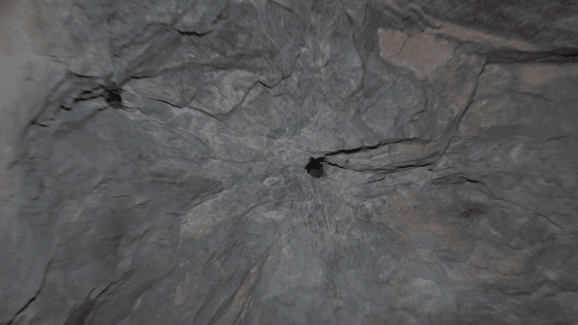 Inside a rocky cave with a small hole