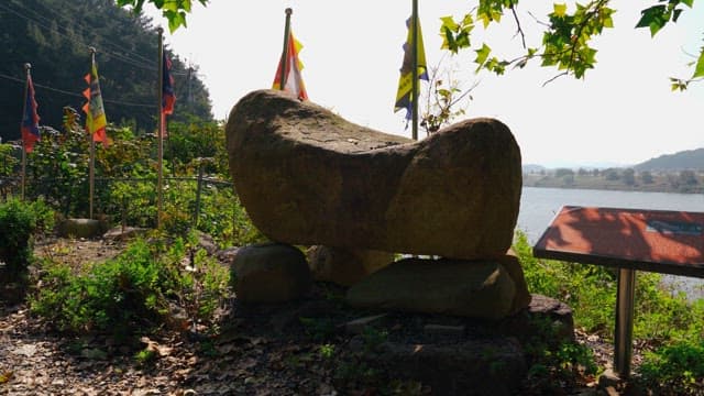 Rock tower surrounded by trees and greenery