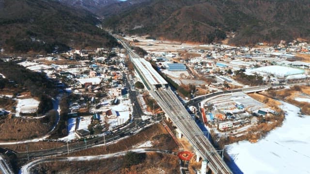 Aerial View of Snow-Covered Train Station in Town