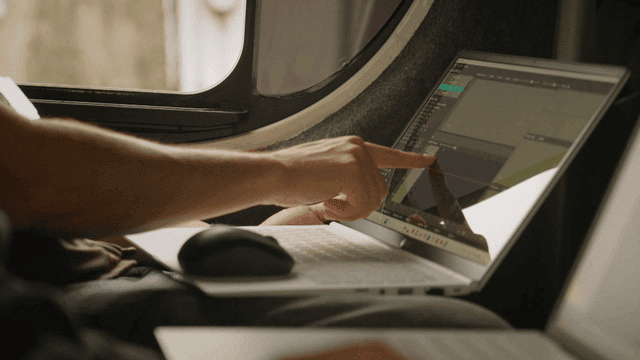 Person pointing at a laptop screen