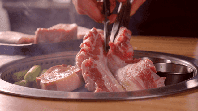 Grilling pork belly on a Korean BBQ grill