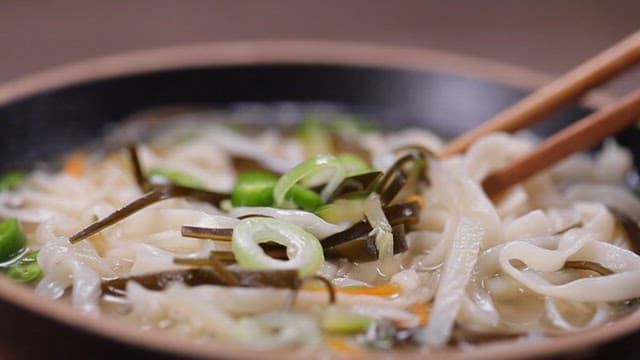 Chopstickful of kalguksu noodles with added kelp for extra flavor