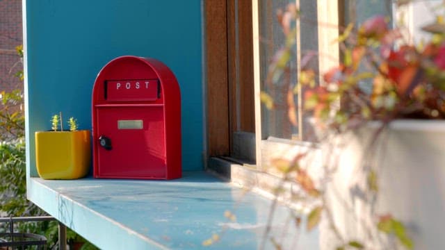 Red mailbox on a sunny window