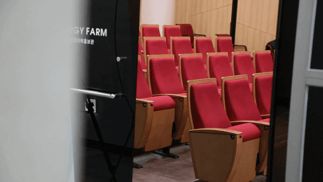 Empty lecture hall with red seats