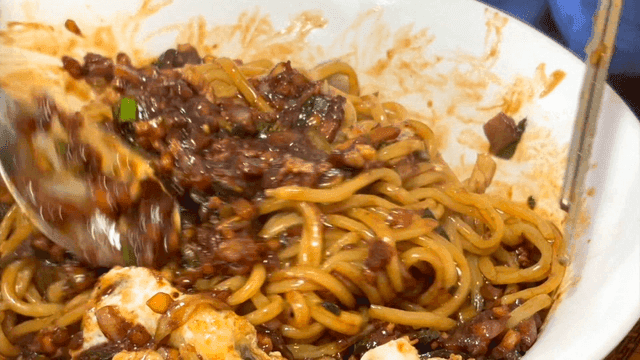 Jajangmyeon being mixed in a bowl
