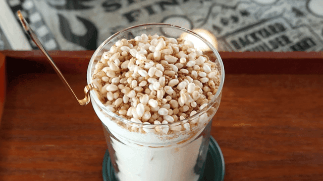 Cup of latte topped with grains