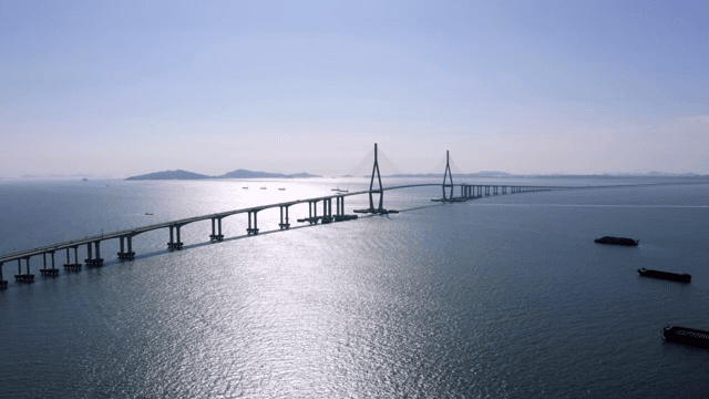 Long bridges and boats on a calm, sunlit sea