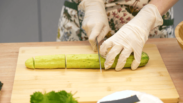 도마 위에서 오이를 일정한 크기로 자르는 모습