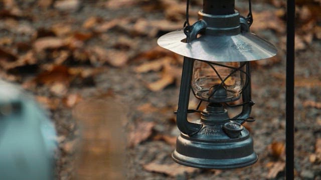 Person Illuminating a Lantern with a Torch