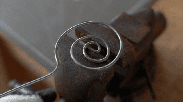 작업장에서 금속 와이어를 구부리는 모습