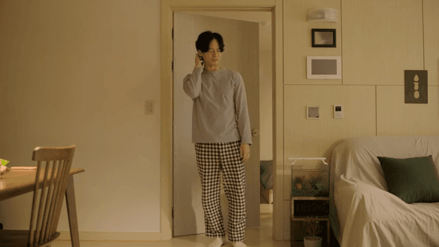 Man comes out of his bedroom stretching