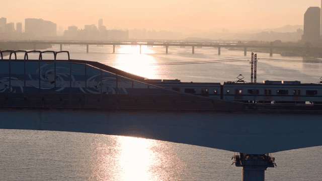 Train crossing a bridge at sunset