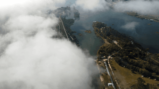 Tranquil lake surrounded by fog