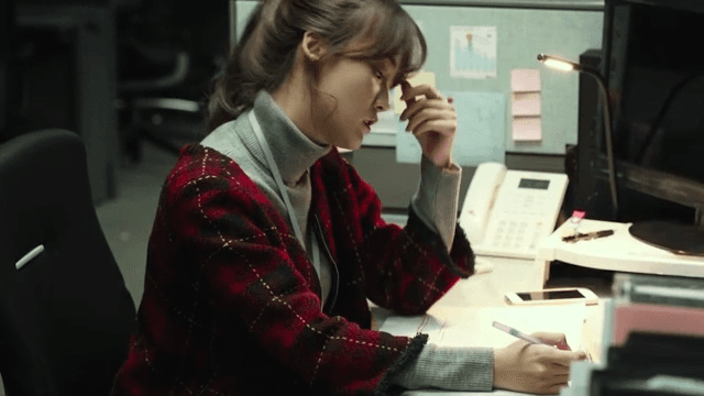 Woman working late at an office desk