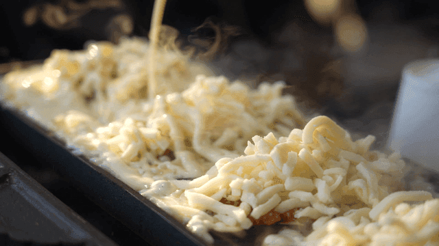 Cheese melting on hot fish-shaped bread grill