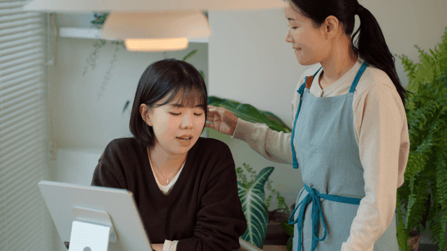 Mother nags her daughter for looking at her phone instead of studying.