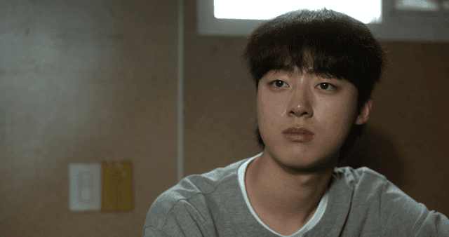 Young man sitting with blank expression