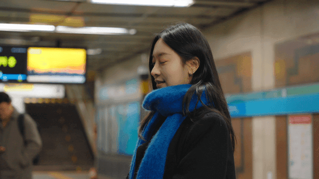 Profile of a woman waiting at a subway station