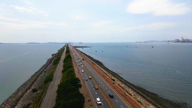 Long coastal road with cars driving