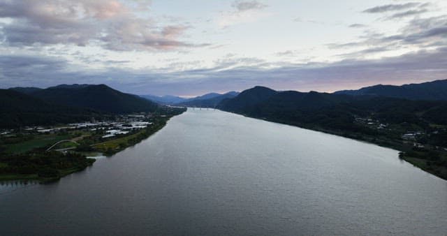 Wide river flowing between mountains