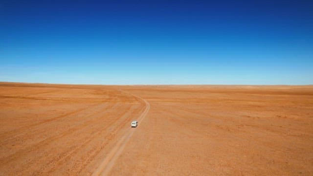 Car Traveling Along a Desert