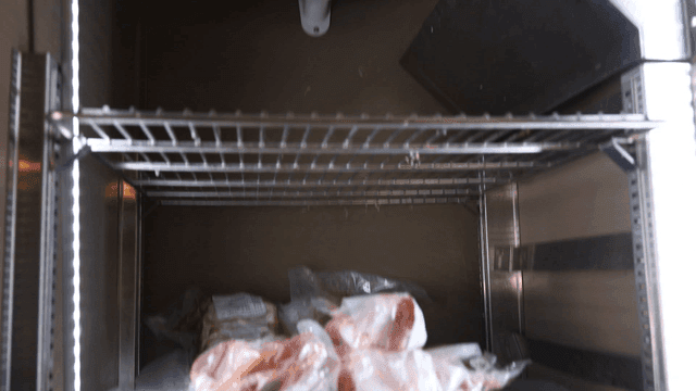Meat placed on industrial refrigerator shelves