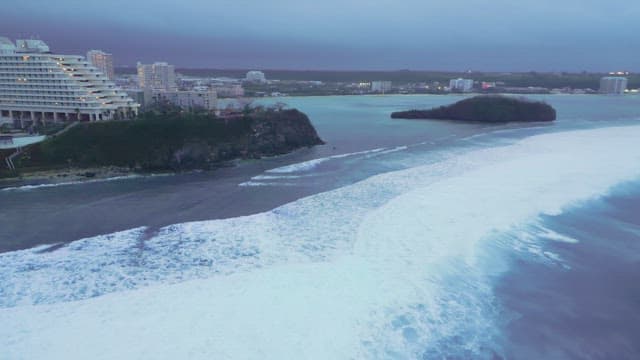 Coastal cityscape with waves crashing