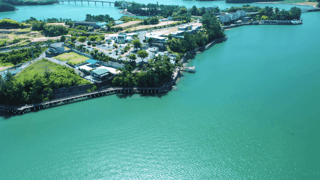 A scenic coastal village with lush greenery