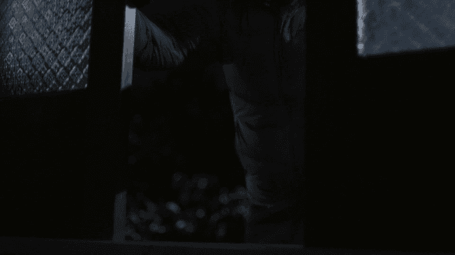 Person entering through a dark door