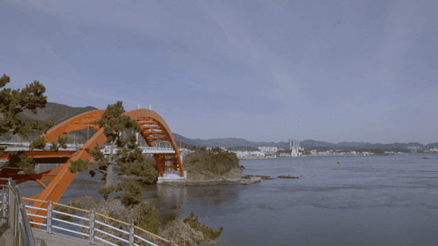 Vibrant orange bridge over calm sea