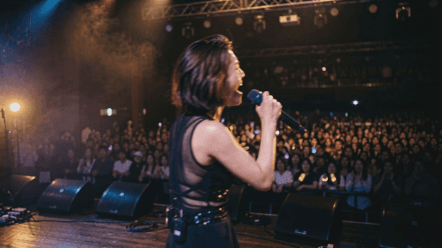 Singer singing passionately on stage