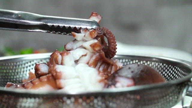 Fresh octopus being prepared in a kitchen