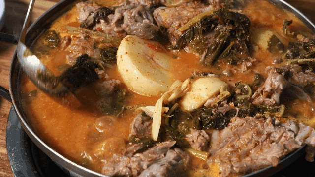 Gamjatang with rich broth containing meat and vegetables