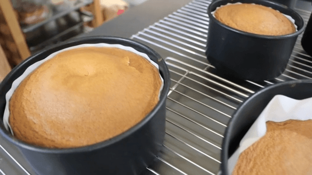 Freshly baked cakes cooling on a rack
