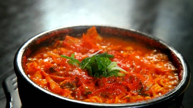 Spicy seafood ramyeon boiling in hot pot