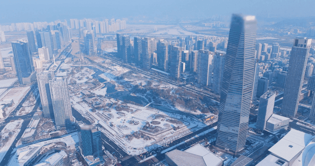 Snow-covered cityscape with tall buildings