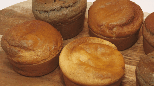 Various muffins on a wooden plate