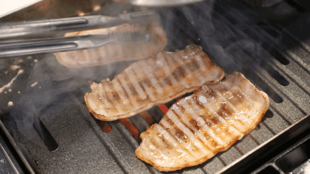Thin pork belly grilled on hot grill